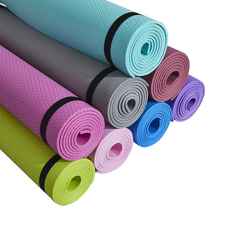 Yoga Mat Fitness Moisture-proof Thickened EVA in various colors stacked neatly.